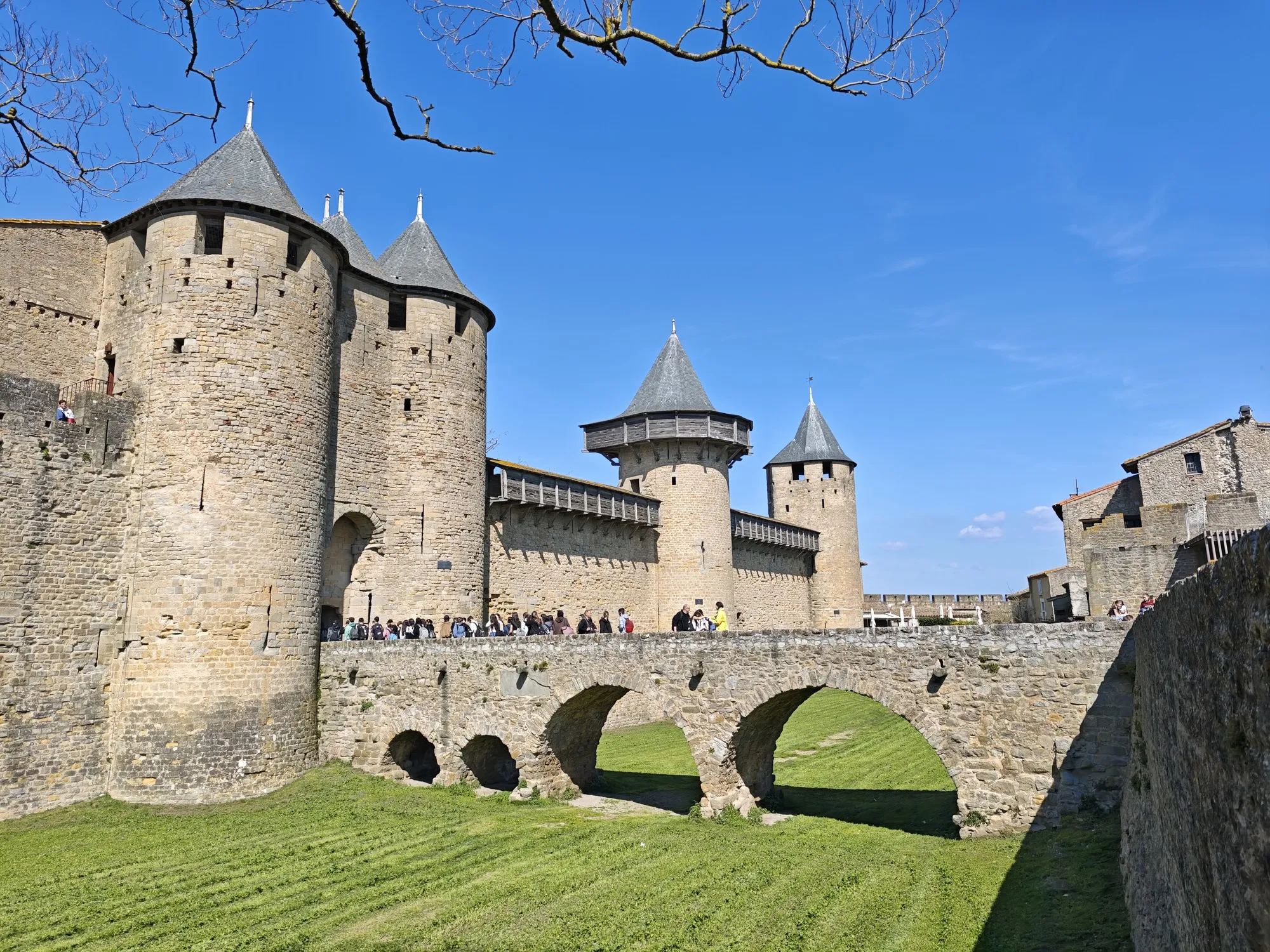 The Château Comtal at Carcassonne, with a school group filing across the bridge into the cité, the largest crowd we met all week.