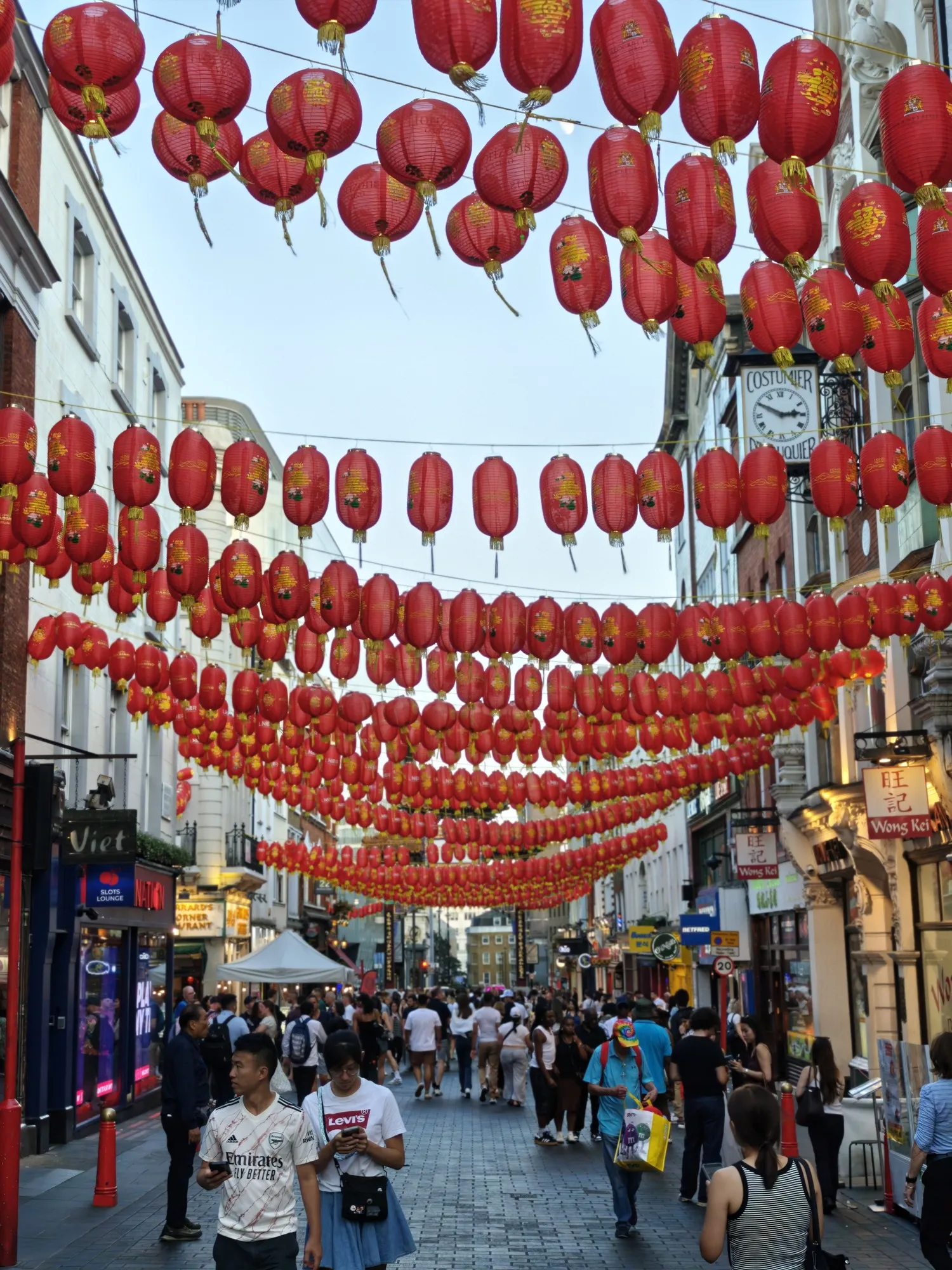 Rows of red lanterns strung over a busy Chinatown street, just north of Leicester Square.