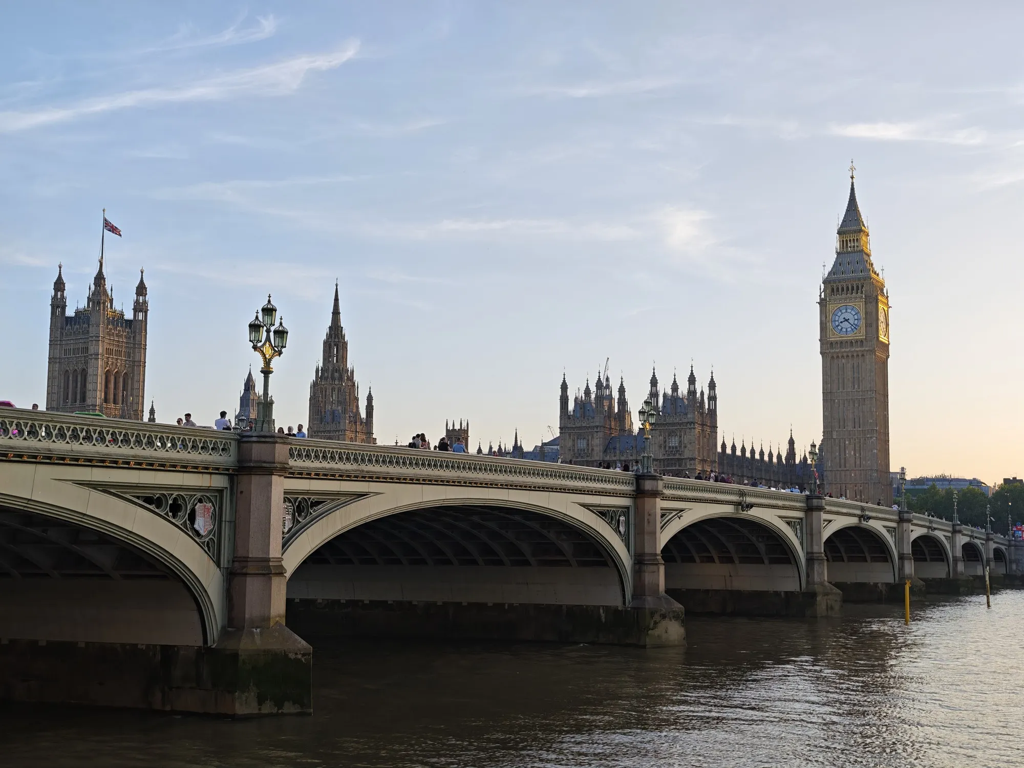 Westminster Bridge near sunset, the Elizabeth Tower still catching light while the rest of Parliament slips into shadow.